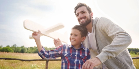 Dad and child flying plane