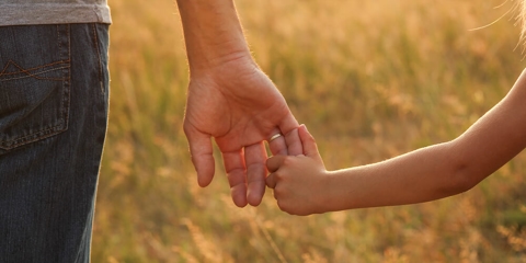 Parent holding hands with child