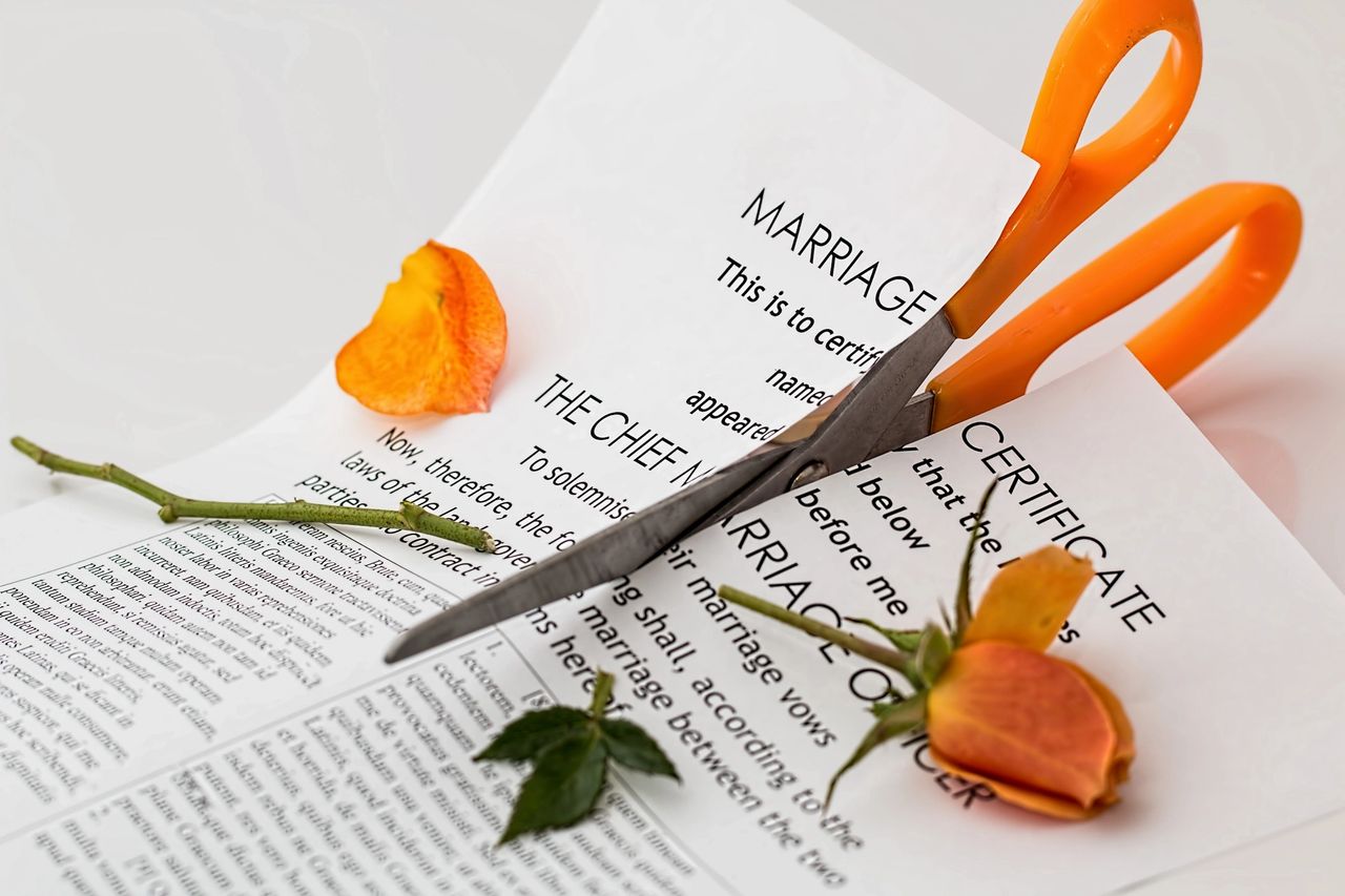 Scissors cutting Marriage Certificate