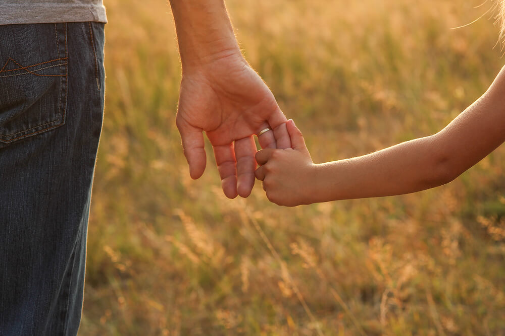 Parent holding hands with child